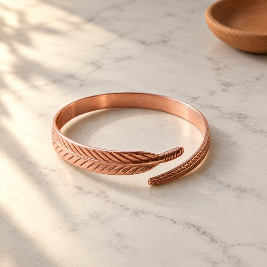 June's Feather Copper Bracelet – pure copper bracelet on a warm neutral background - photo 1