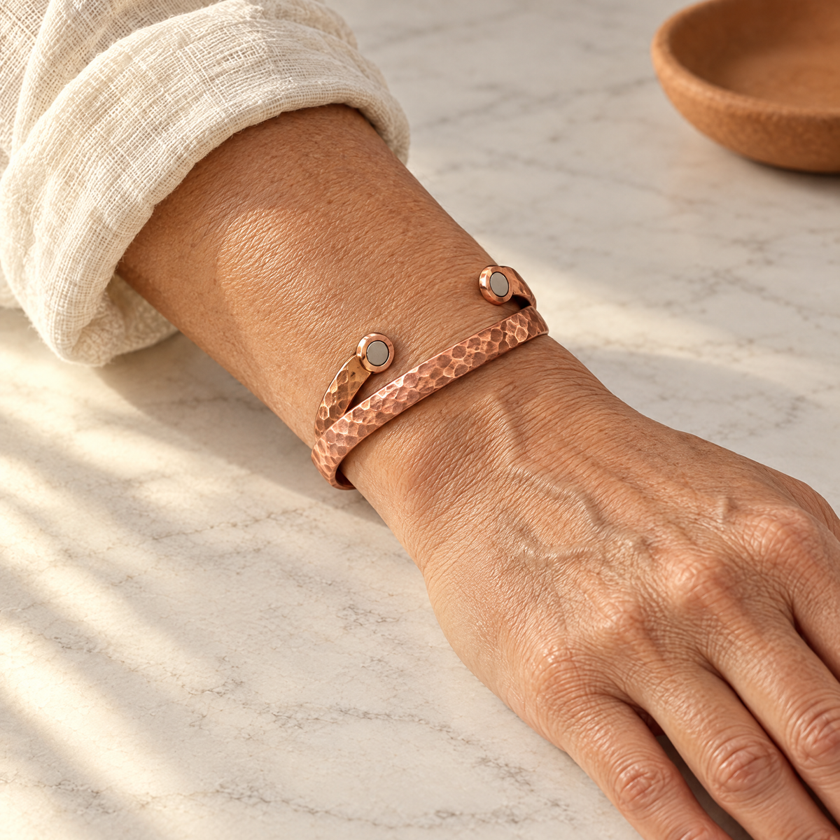 June's Lodestone Copper Bracelet – pure copper bracelet on a warm neutral background - photo 2